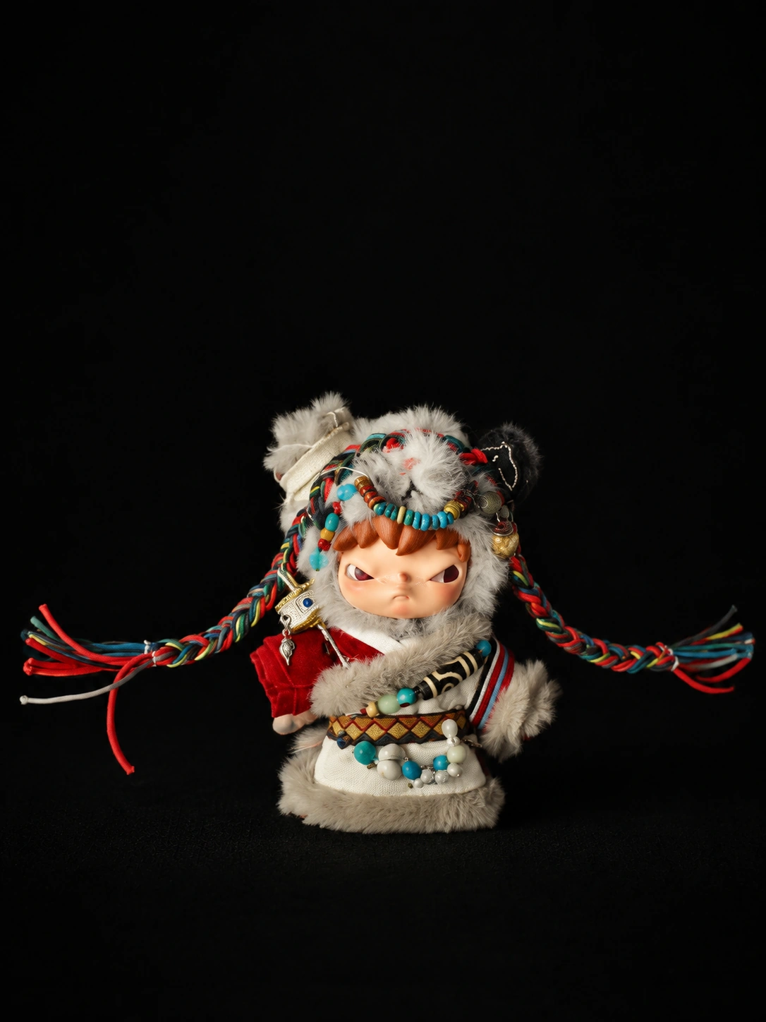 TIRAVA independently customised character with ivory plush, red and blue woven cords and turquoise-colour details