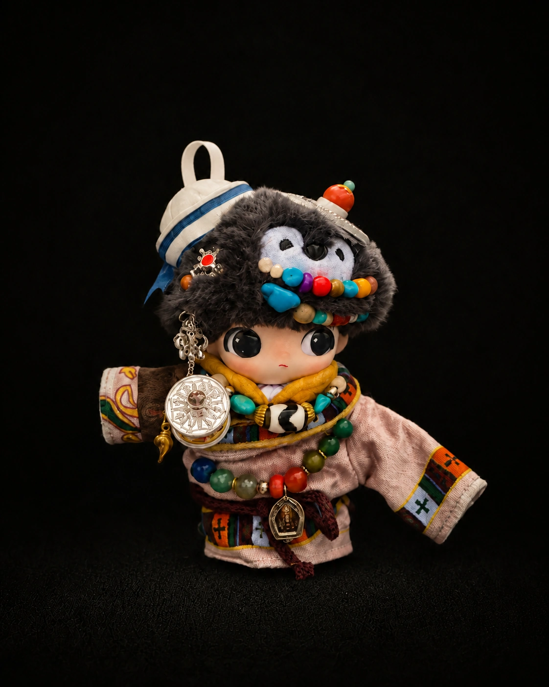 TIRAVA independently customised charcoal plush character with blue and white cap and bright layered beads